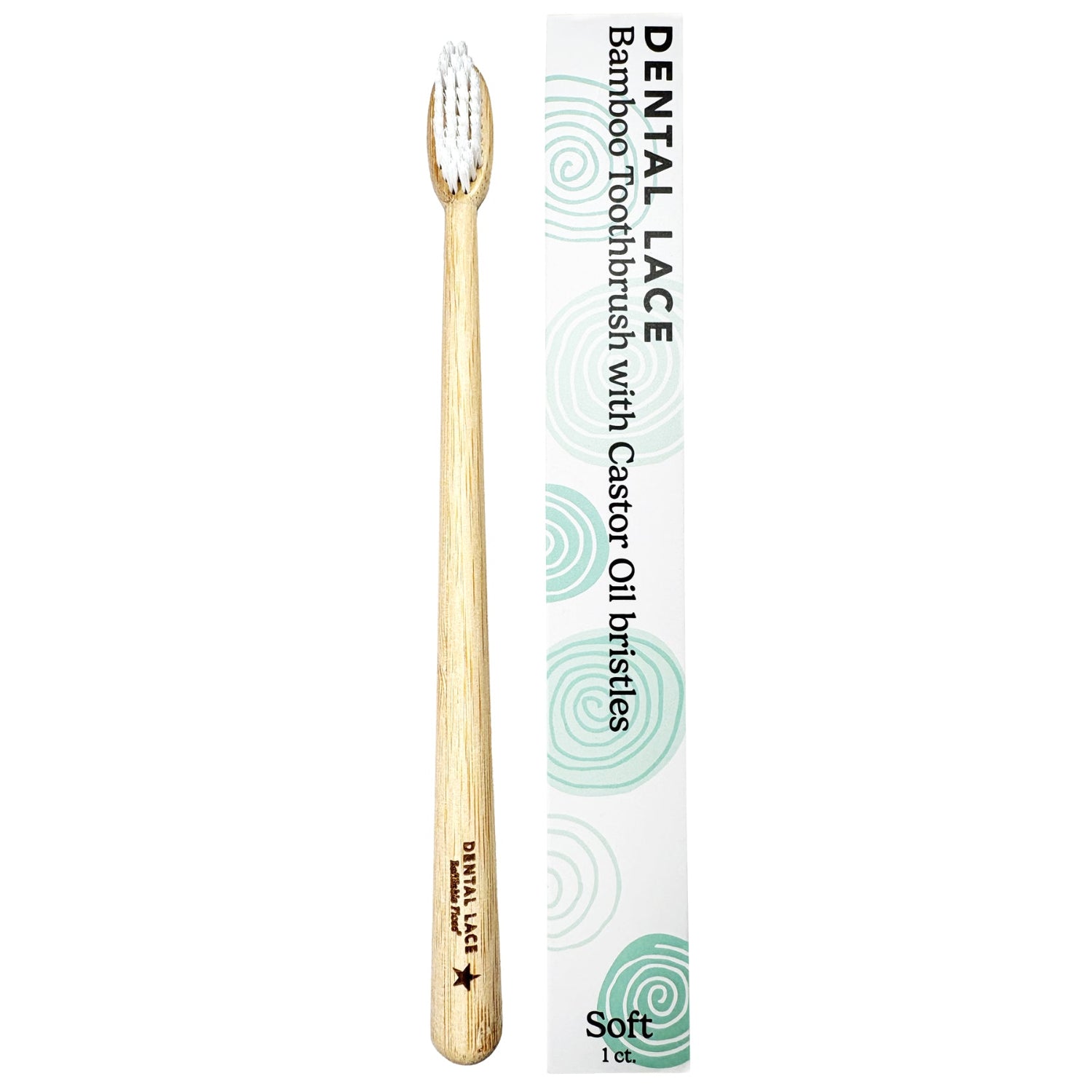 A bamboo toothbrush with soft bristles next to its white packaging box, which features green swirl patterns and the text &