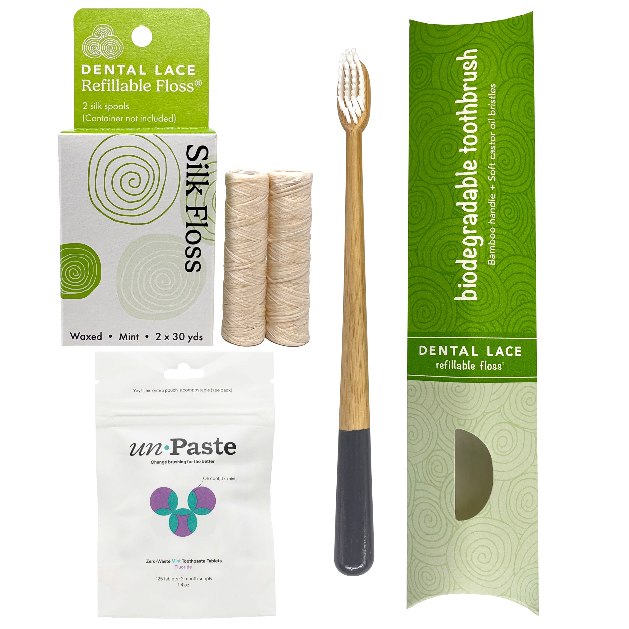 Dental care products including a biodegradable toothbrush, silk dental floss refills, and unpaste fluoride toothpaste tablets on a white background.