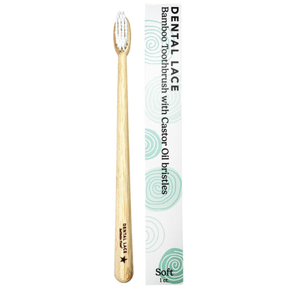 A bamboo toothbrush with soft bristles next to its white packaging box, which features green swirl patterns and the text &