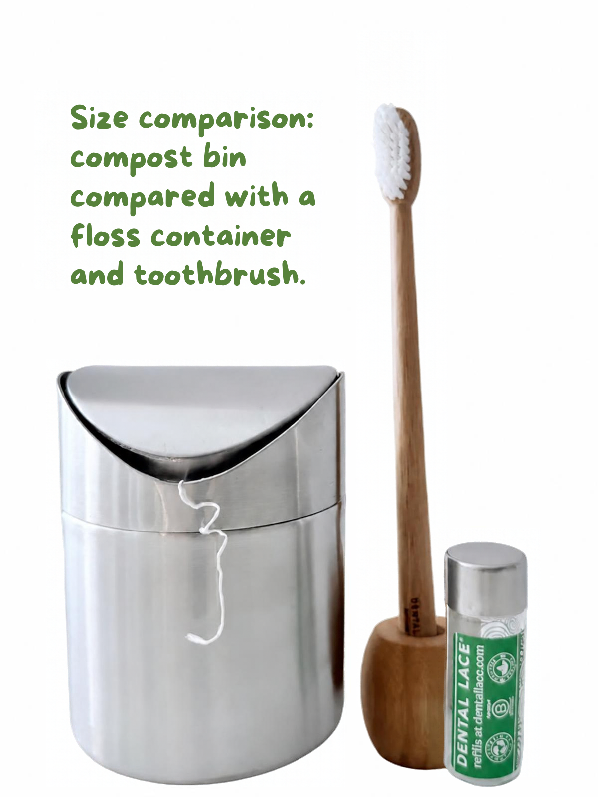 A stainless steel compost bin shown next to a wooden toothbrush in a brush holder and a small green-and-white tooth floss container, with green text reading &