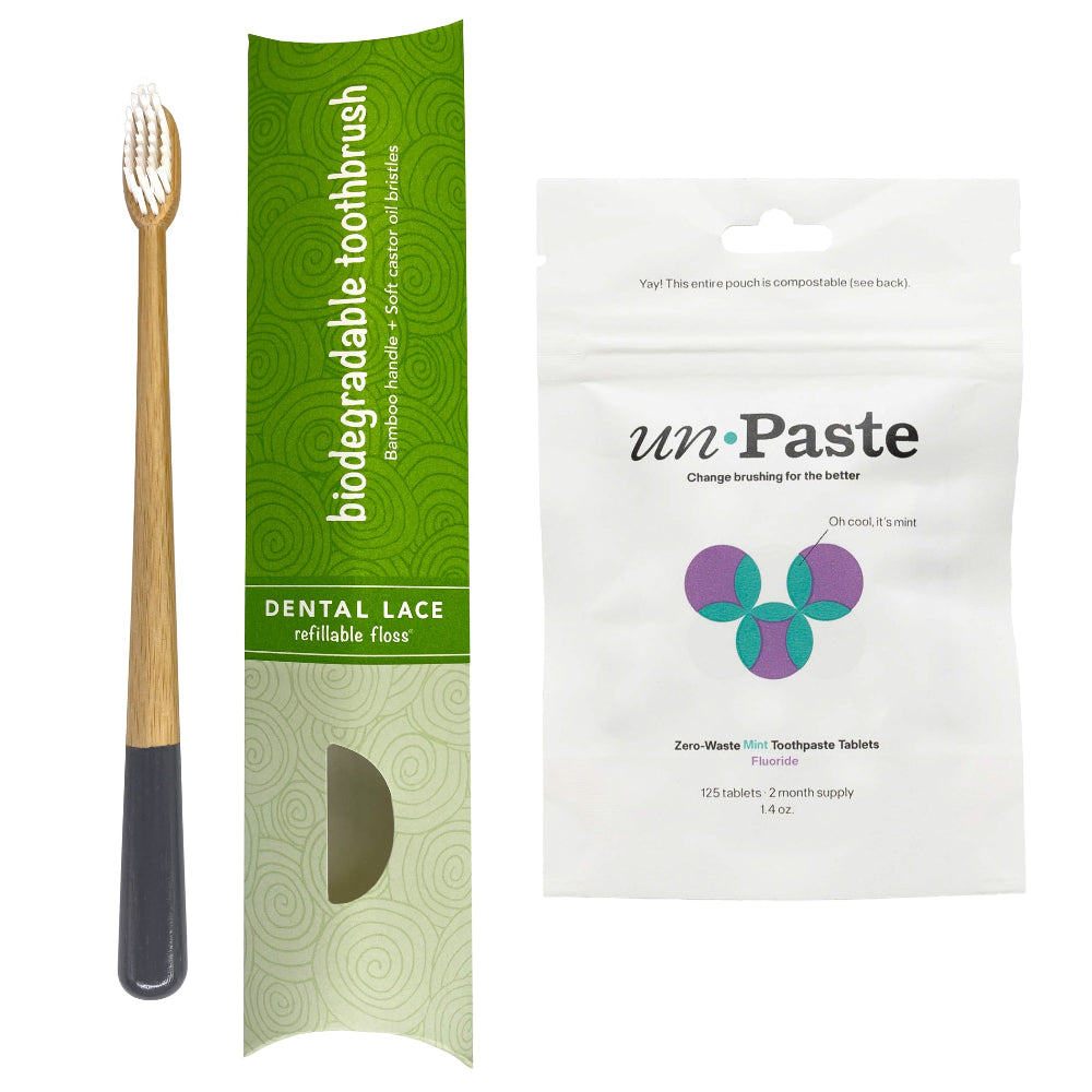 Gray toothbrush with green box and the front of a unpaste fluoride toothpaste tablets bag. 