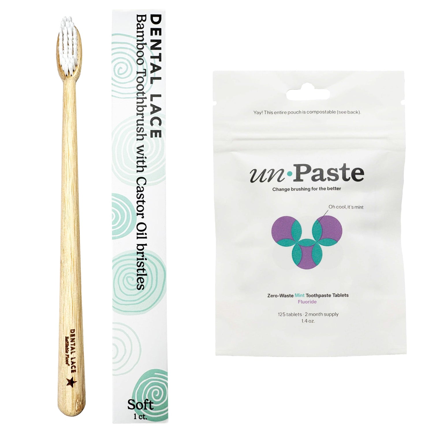 A bamboo  toothbrush with a light wood handle and white bristles, shown next to its white packaging sleeve and a white unpaste toothpaste pouch on a plain white background.