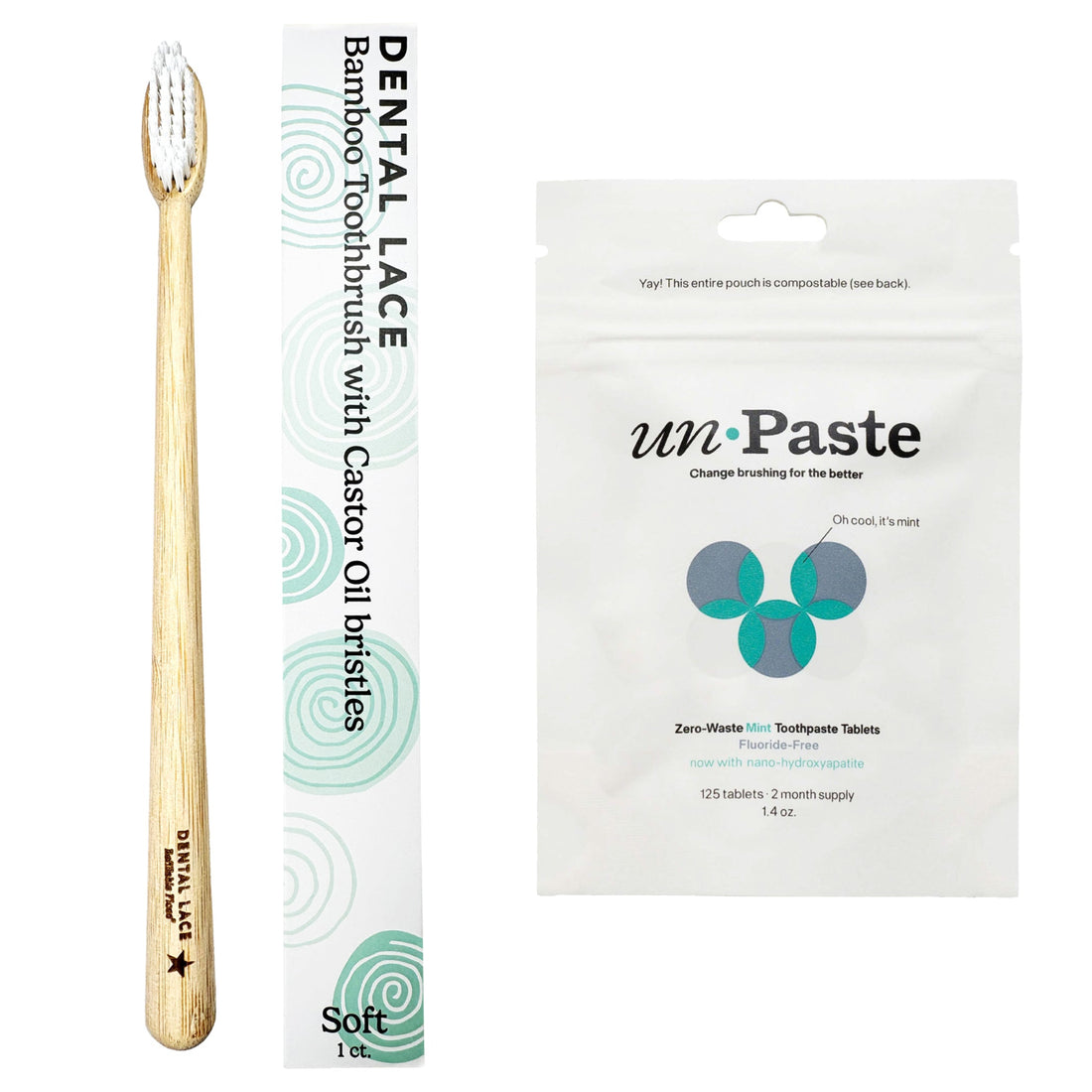 A bamboo toothbrush with a light natural wood handle and white bristles stands next to its white and mint green packaging. To the right is a white stand-up pouch of un:Paste toothpaste tablets.