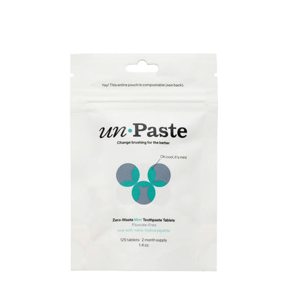 Package of unpaste zero-waste mint toothpaste tablets on a white background